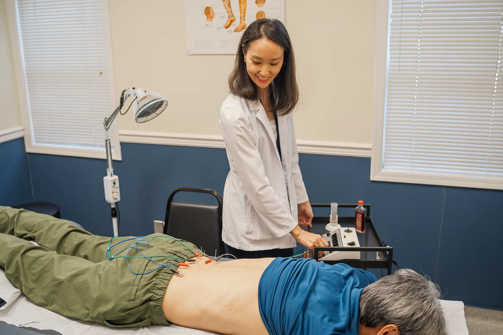 Dr. Choe performing electroacupuncture treatment at Holistic HealthPlus